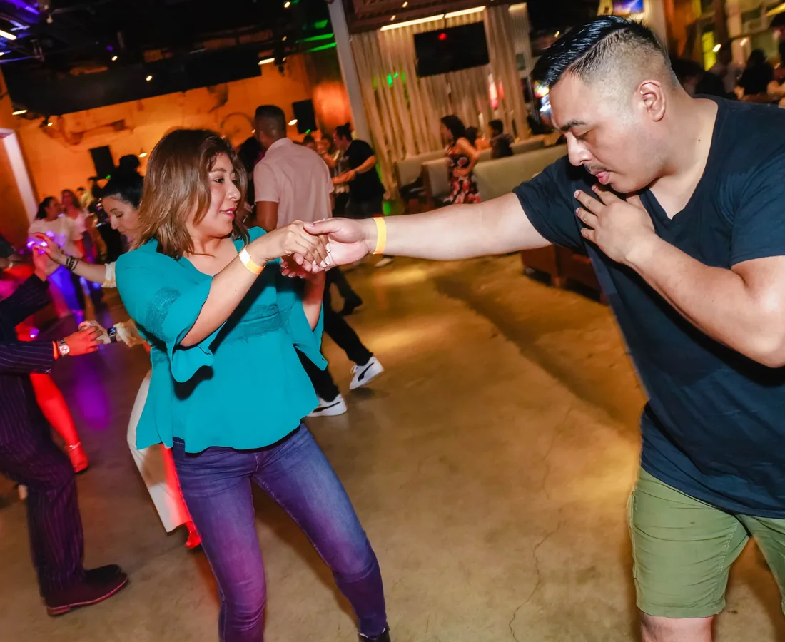 A lead and follow mid-turn on the Vedanza social floor