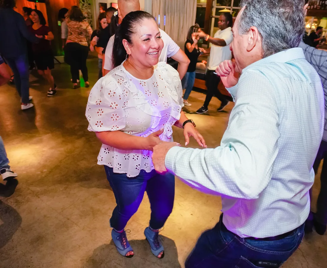 Dancers laughing at a Vedanza social